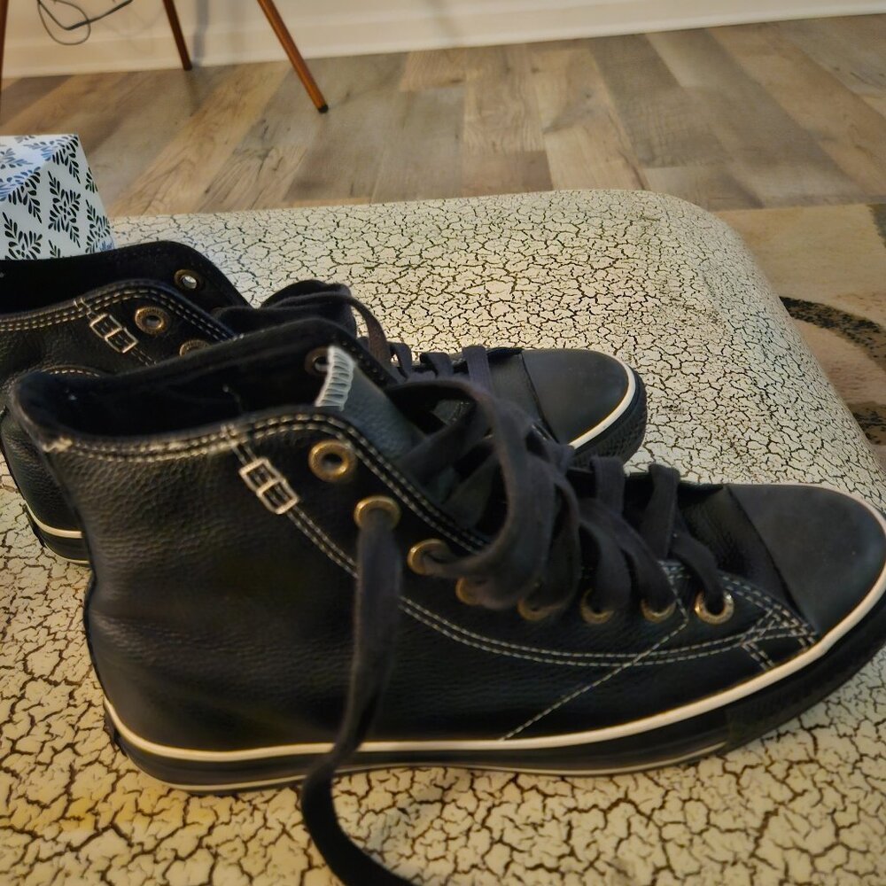 Converse  black leather high top sneakers.